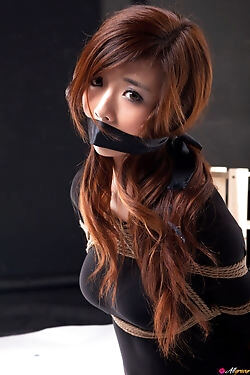 This Asian babe enjoys shibari and gets trussed up and gagged for the camera